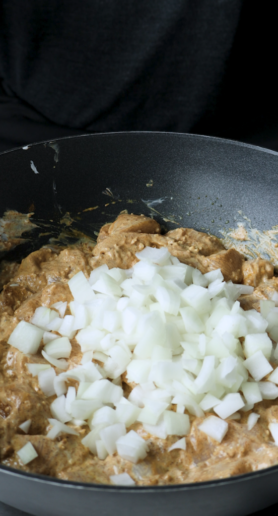 greek yogurt and garlic and spices in chicken and diced onion